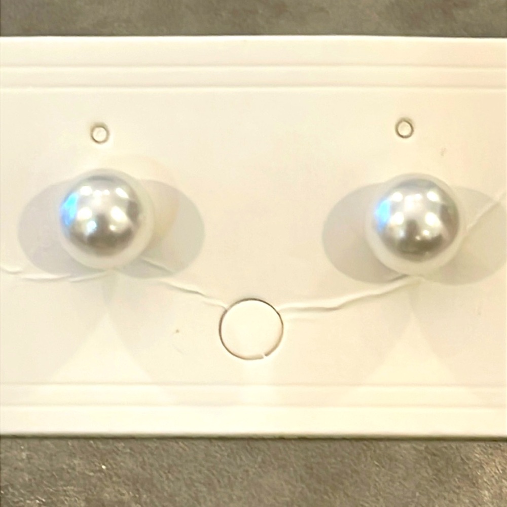 A pair of classic 8 mm faux pearls stud earrings